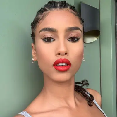 Imaan Hammam in red lipstick with cat wing liner.