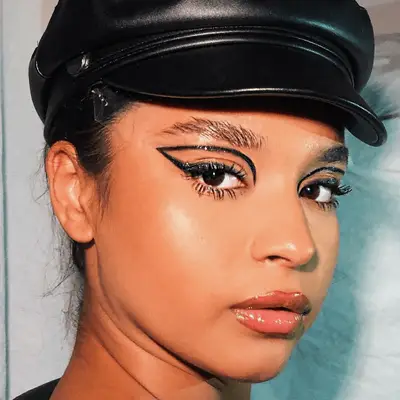 A person with bronde braids in a neutral makeup look.