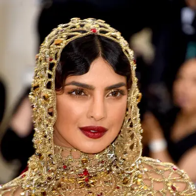 Priyanka Chopra in gold eyeshadow with red lips.