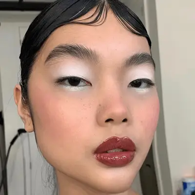 Rihanna with a sunset bronze eyeshadow look and red lips