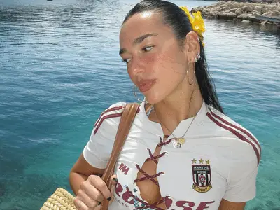 Dua Lipa in front of water