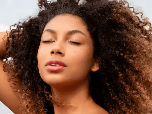 A woman with her eyes closed showing long lashes