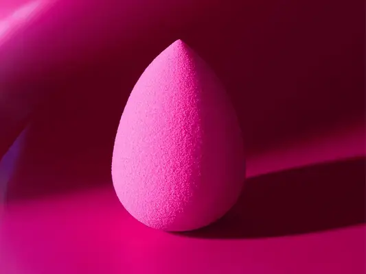 close up of pink beautyblender on pink background