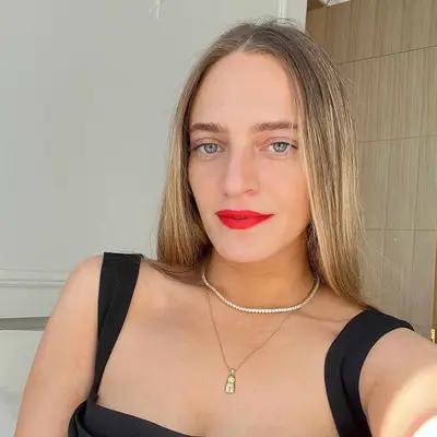 Close up of Star Donaldson in red lipstick, headphones over her ears