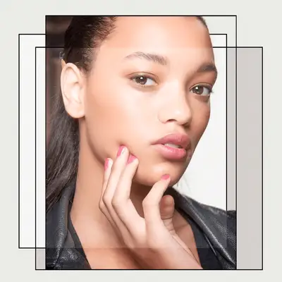 Portrait of Woman With Feathered Eyebrows and Dewy Skin 