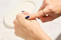 Person tests Hourglass Voyeur Waterproof Gel Eyeliner on their hand