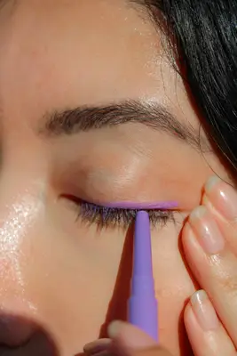 A person applying MAC Colour Excess Gel Pencil Eye Liner to their eye