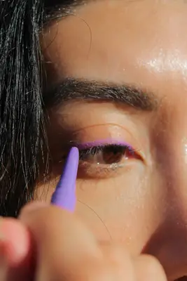 A close-up of a person applying MAC Colour Excess Gel Pencil Eye Liner to their eye