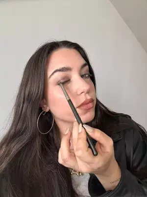 Three people with different skin tones wearing different eyeshadow palettes