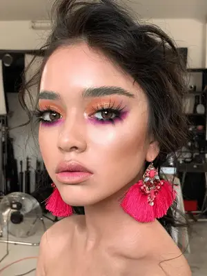 Model wears soft copper eyeshadow accompanied by highlighted skin and neutral lip