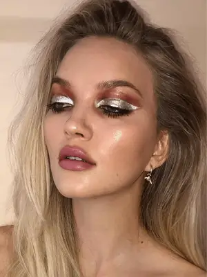 model with dark skin wears bright copper metallic shadow on the lids