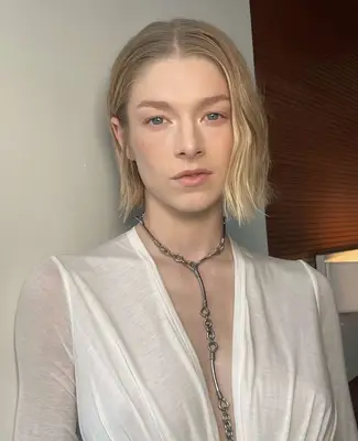 Hunter Schafer wears light, natural makeup with white eyeshadow applied to the inner corners of the eyes