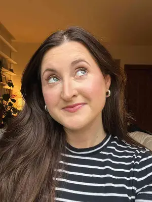 A person after applying the Saie Mascara 101 in Rich Warm Brown