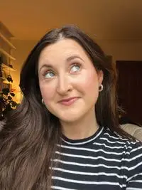 A person after applying the Saie Mascara 101 in Rich Warm Brown