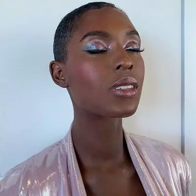 Jodie Turner-Smith wears pink glitter eyeshadow and soft pink cheeks and lips
