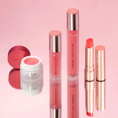 array of rare beauty products lined up against beige background 