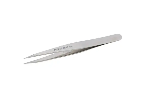 Hand plucking facial hair with the Benefit Grooming Tweezer & Brush