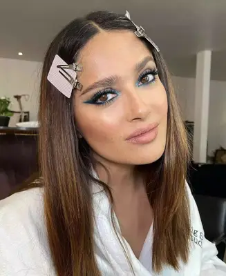Salma Hayek wears a robins egg blue and black graphic liner and shadow look