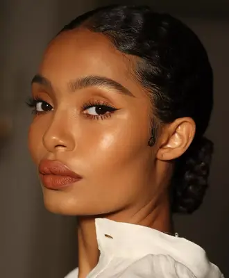 Yara Shahidi models a clean eyeshadow look with precise black wing liner