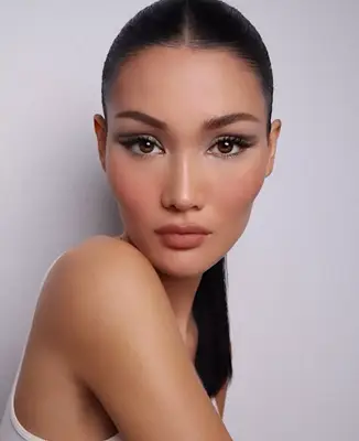 model poses wearing a 60s inspired shadow look with light and dark grey tones