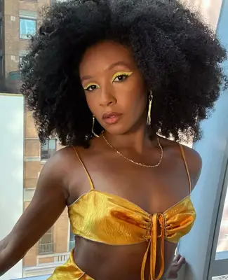 Nabiyah Be is modeling thick pastel yellow winged eyeliner