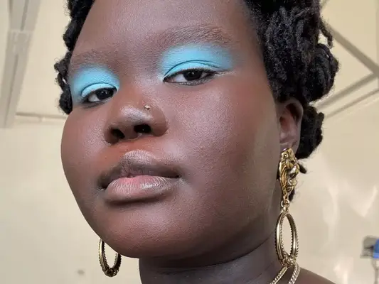a model wears matte blue eyeshadow