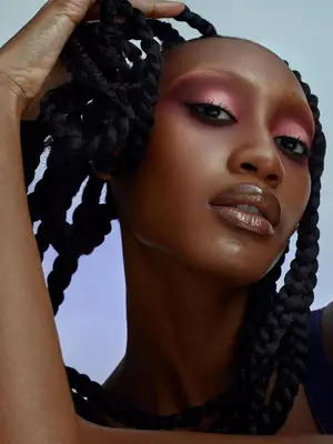 model wearing glossy lips and red and pink eyeshadow