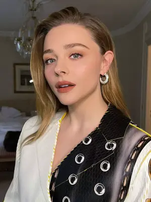 model wearing orange eyeshadow and matte orange lipstick