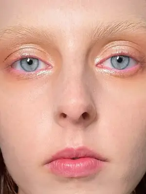 model wearing pink eyeliner and glossy eyeshadow