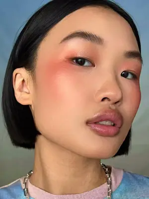 woman wearing orange draped eyeshadow and blush