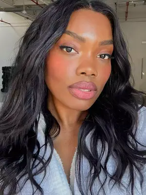 model wearing blush and pink lipstick