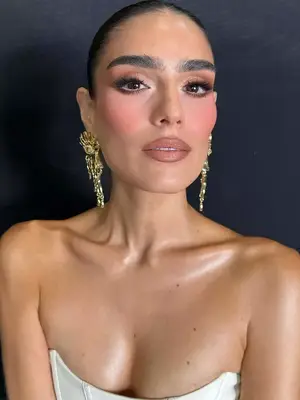 model wearing rosy blush and contoured cheeks