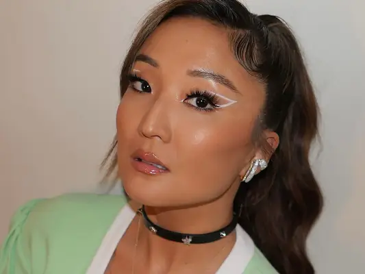 Close up of actor Ashley Park with a lashy makeup look