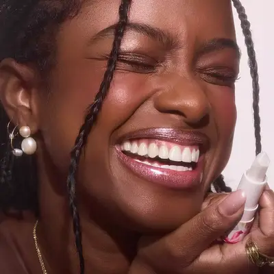 model wearing shimmering eyeshadow and lipgloss