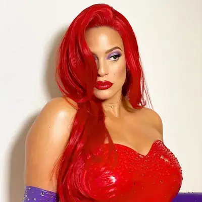 Ashley Graham wears a Jessica Rabbit Halloween costume with purple eyeshadow and red lipstick