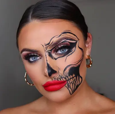 Woman with soft glam eye makeup, red lipstick, and half-skull outline makeup