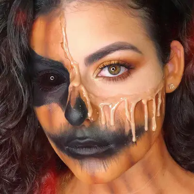 Woman with melting orange haunted jack-o-lantern look with black contact