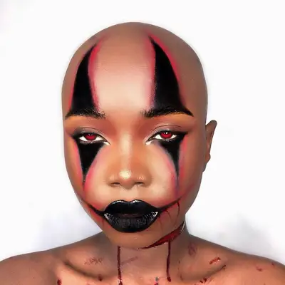 person in black and red creepy clown makeup
