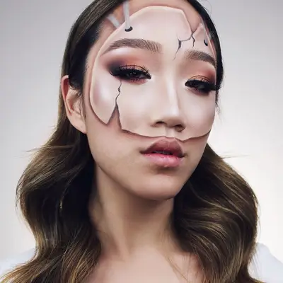Woman with realistic porcelain half-mask makeup look