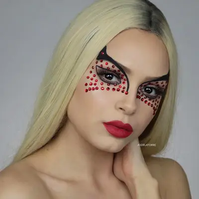 Woman with Cat Woman mask-shaped brow liner and red gems