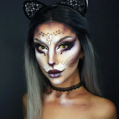 Woman with glamorous cat-inspired makeup look and ears headband