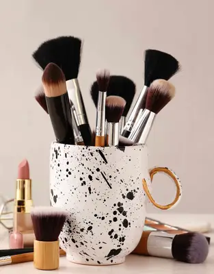 Makeup brushes in coffee cup