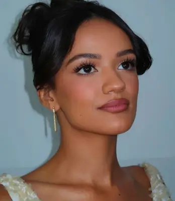 model wears false eyelashes and rose lipstick