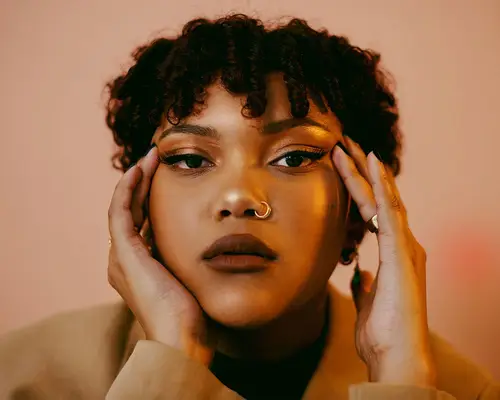 young woman holding temples