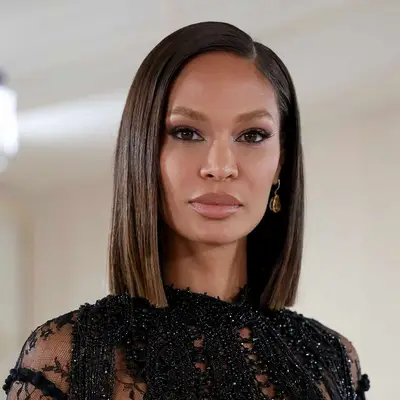 Joan Smalls with straight brows, oblong face shape, and sharp lob attends The 2023 Met Gala Celebrating 