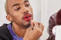 Close up of a person applying red lipstick