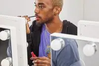 A person applying the Maybelline SuperStay Matte Ink Liquid Lipstick on their lips