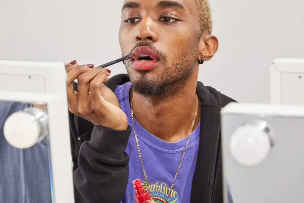 A person applying the Maybelline SuperStay Matte Ink Liquid Lipstick on their lips