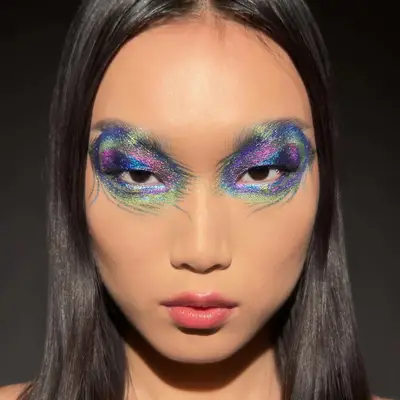 Bold abstract peacock feather eye makeup