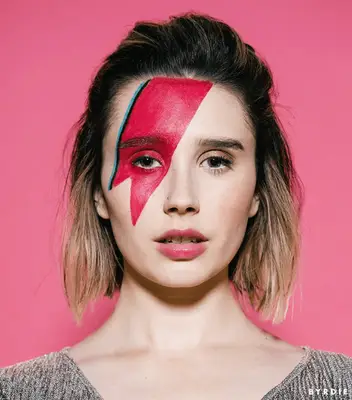 Woman with David Bowie red lightning bolt makeup over eye